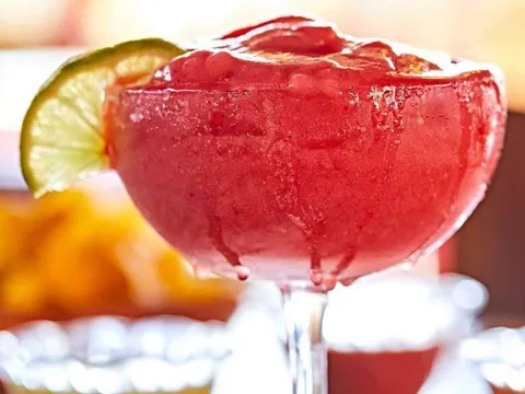 Frozen strawberry margarita with a lime wheel at Rosepepper Cantina