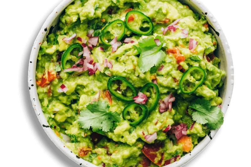 Bowl of fresh guacamole topped with sliced jalapenos and cilantro at El Agave