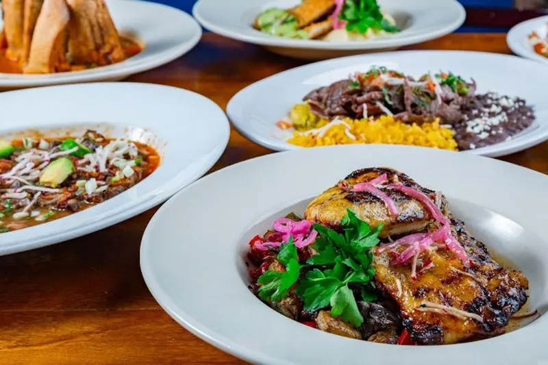 Plated Mexican entrees with rice and black beans at 5 Rabanitos