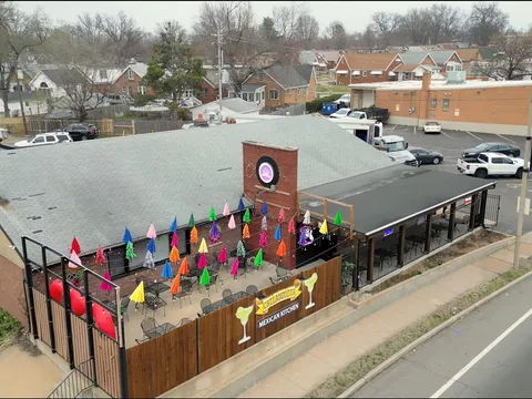 Aerial view of Chilanguita Mexican Kitchen on Chippewa Street, showing its patio lined with brightly coloured umbrellas and the restaurant's margarita-glass sign