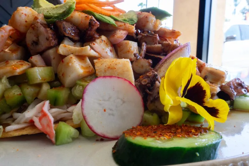 Tostada piled with octopus, shrimp, imitation crab, cucumber, radish and avocado at El Governador in Anaheim