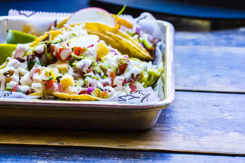 Tray of street tacos with pico de gallo, crema, radish and lime at Midtown's Cantina Alley